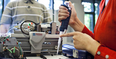 Photo of pipette, linking to Research Programmes